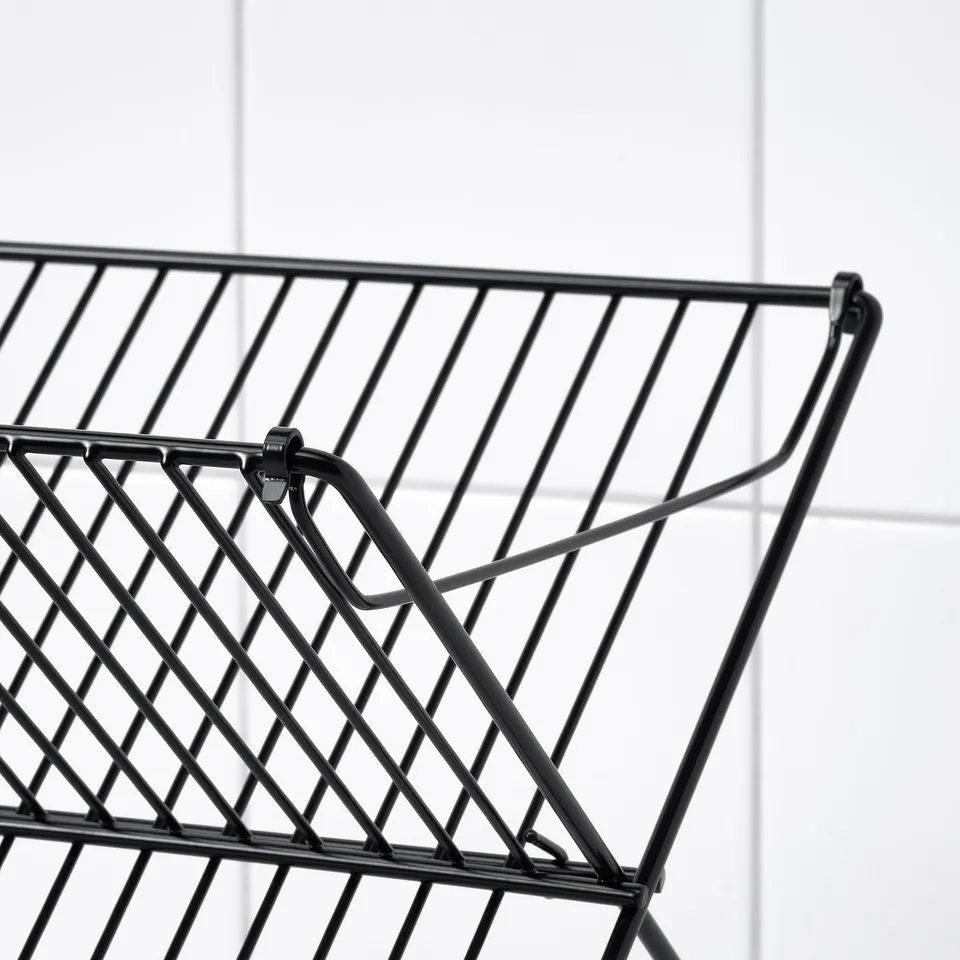 Black wire dish drainer close-up, showcasing intricate crisscross pattern and sturdy design.