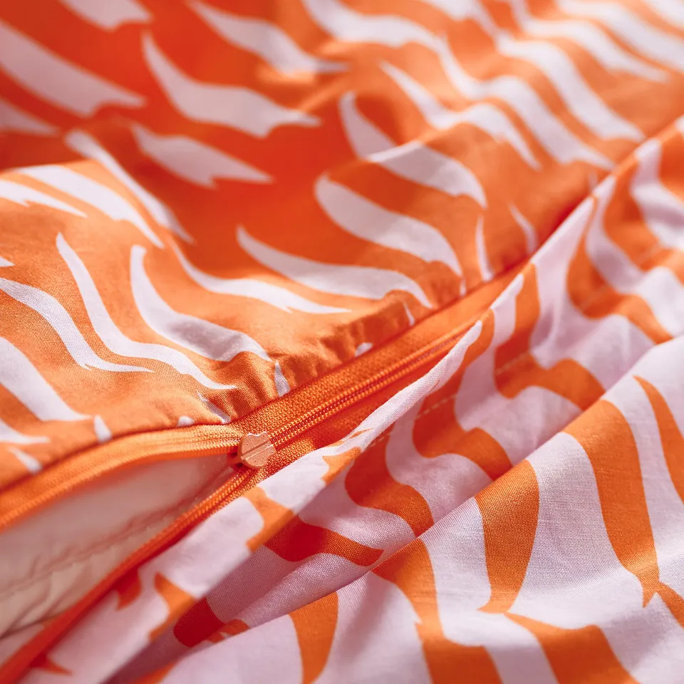 Orange tiger-striped duvet cover with white stripes, featuring a zip closure. Perfect for a childs bed.