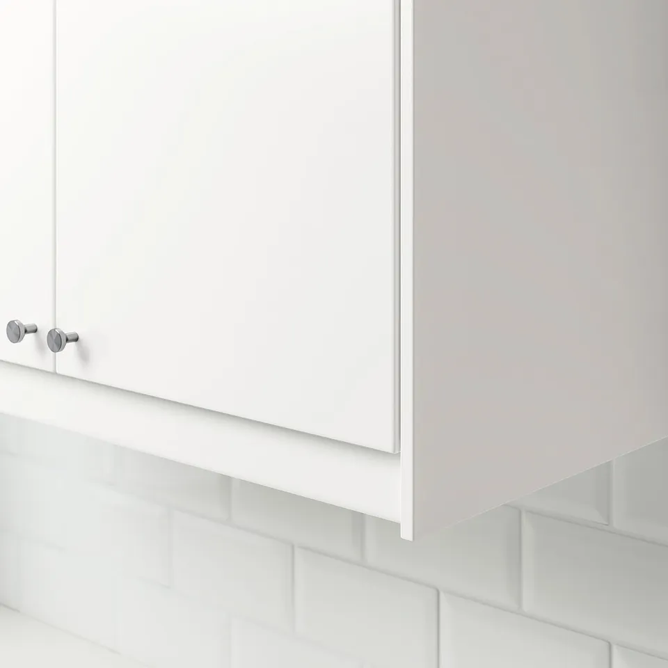 Kitchen cabinet with round knobs and hidden lighting.