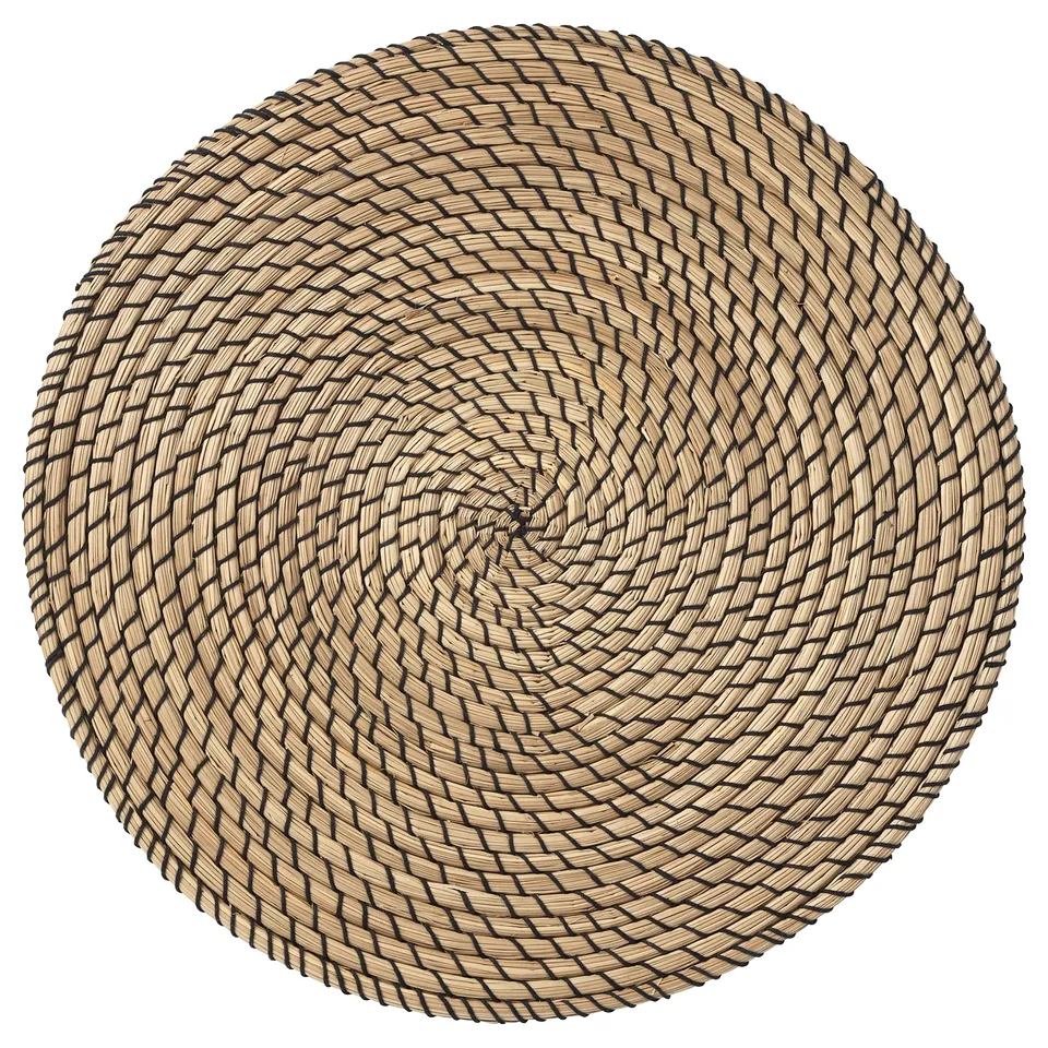 Round, woven seagrass place mat with black outlines.