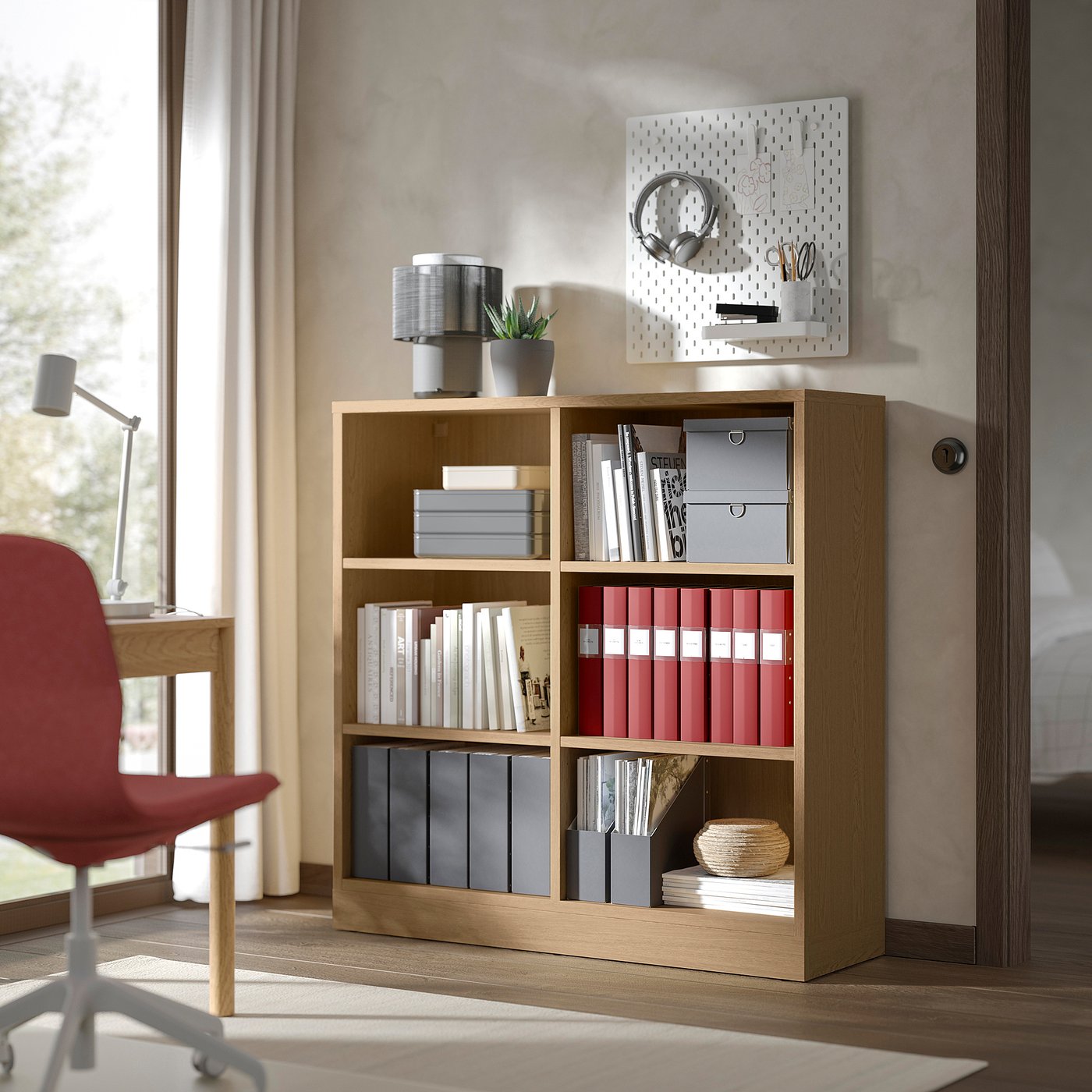 TONSTAD bookcase with light wood, books, files & decor. Pegboard, lamp, red chair, desk by window.
