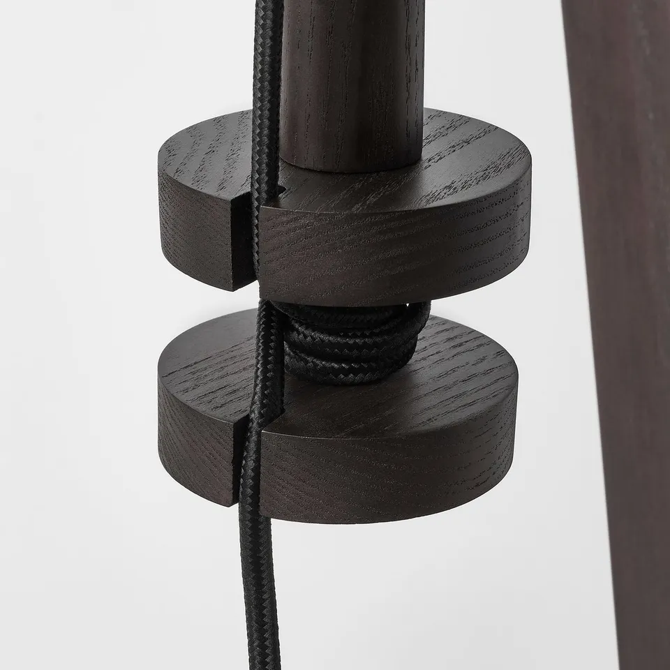 Wooden floor lamp with adjustable height and black cord.