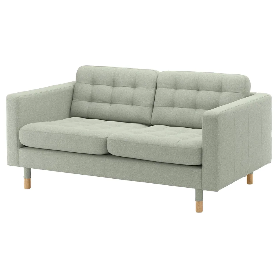 A light grey, modern sofa named LANDSKRONA with wooden legs, a tufted back, and plush cushions.