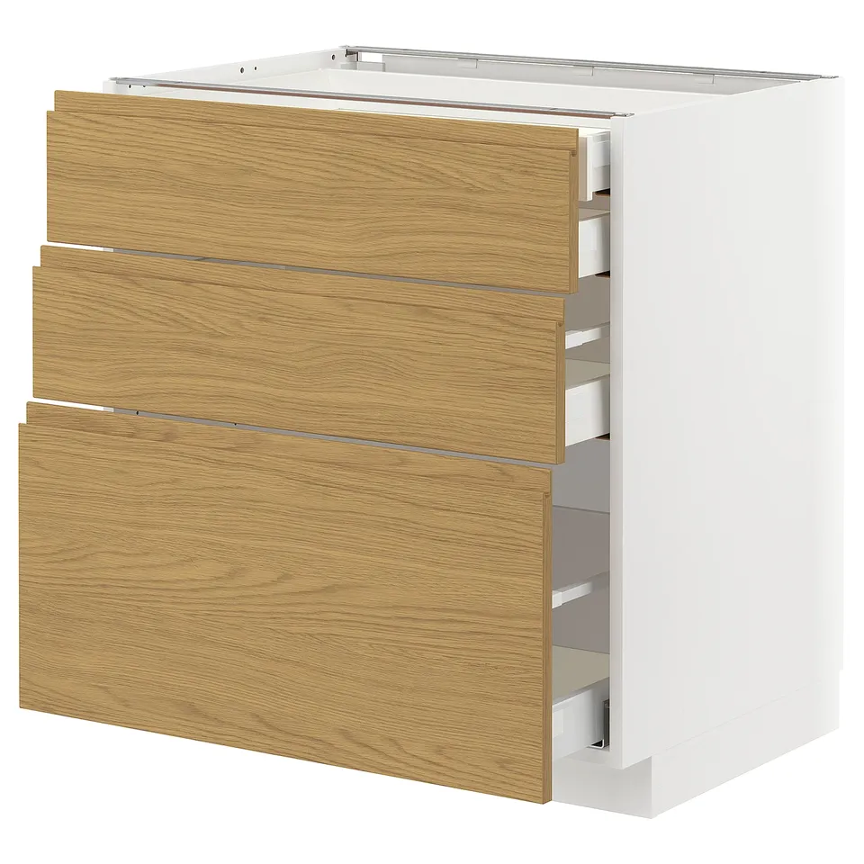 White METOD cabinet with 3 oak drawers, partially open showing organisers, minimalist handles.