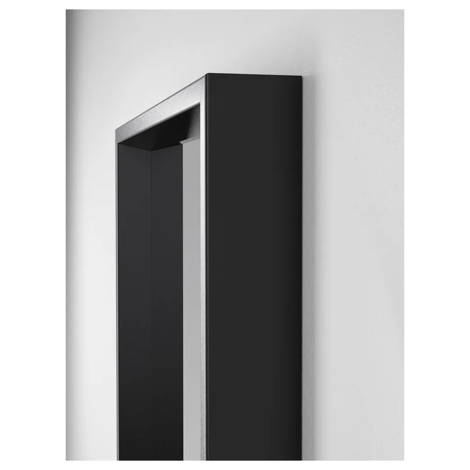 High-quality vertical mirror with modern black frame, mounted on a pristine white wall. Sharp, clean design reflecting excellent craftsmanship.