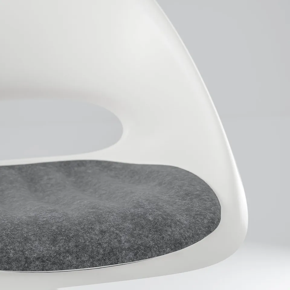 Modern white desk chair with dark cushion.