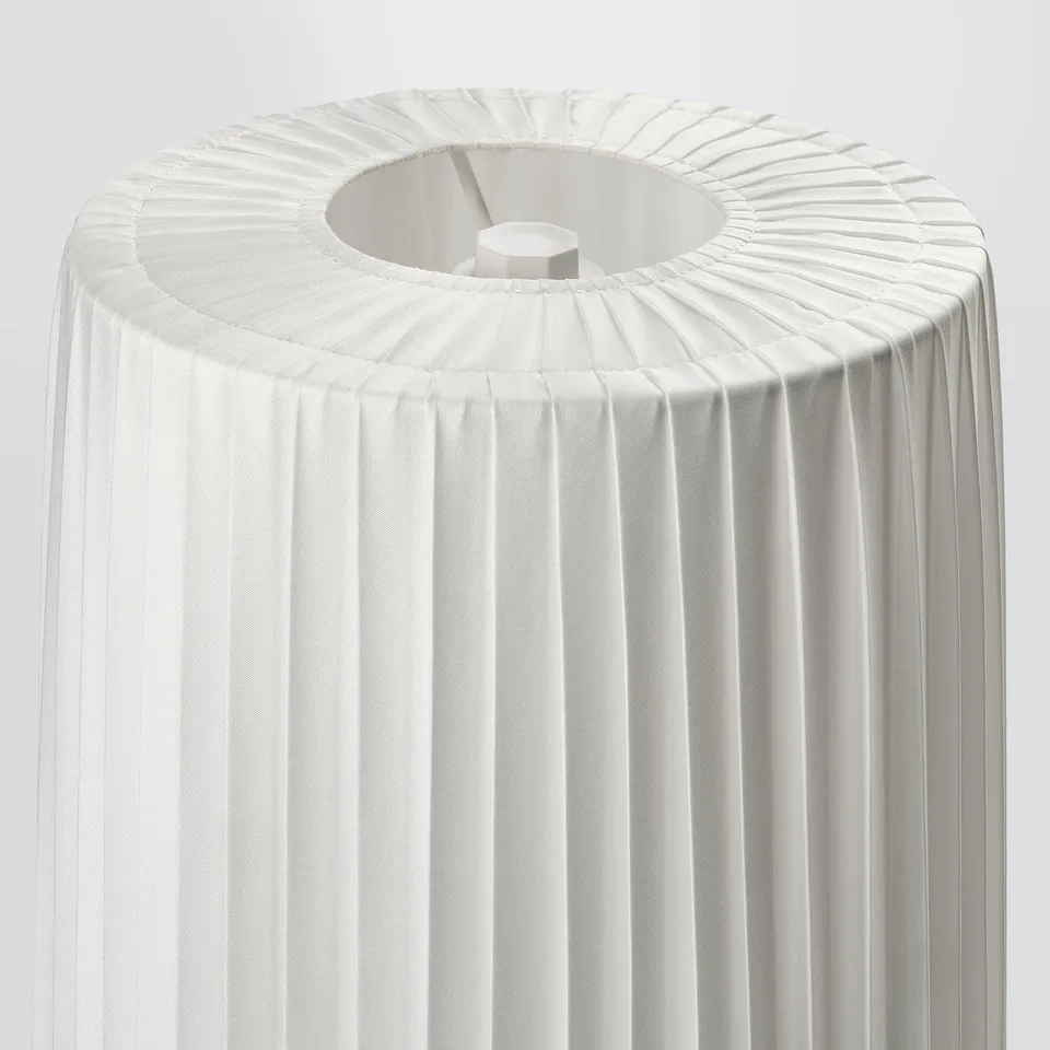 Elegant white pleated lamp shade, likely made from recycled polyester, attached to a simple structure, suitable for soft ambient lighting.