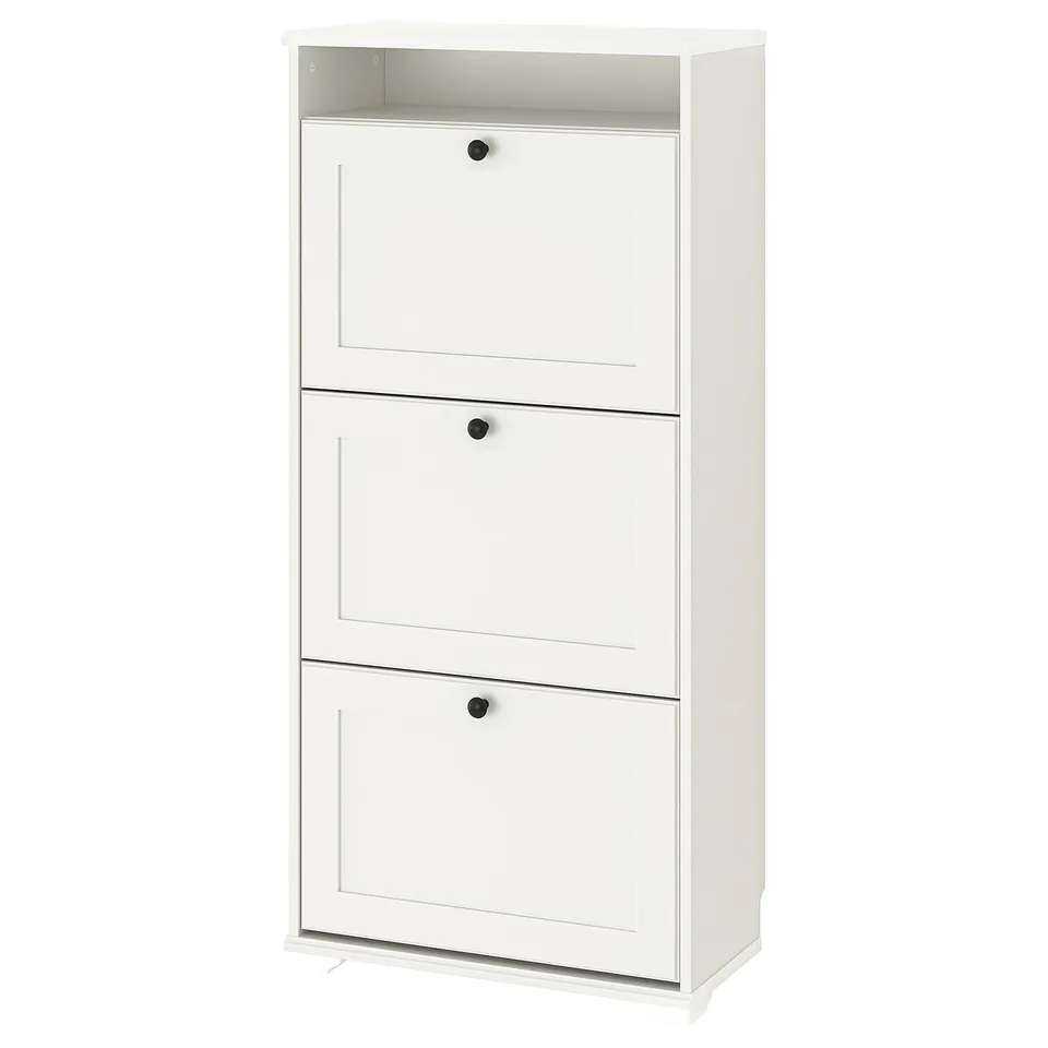 Ikea BRUSALI white shoe cabinet: three sections, flat doors, black knobs.