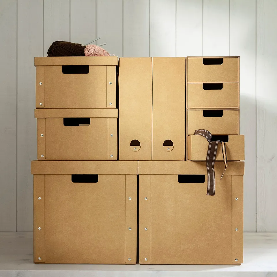 Stacked GÄRDESGÅRD paperboard storage boxes in beige, varying sizes, neat and organised.