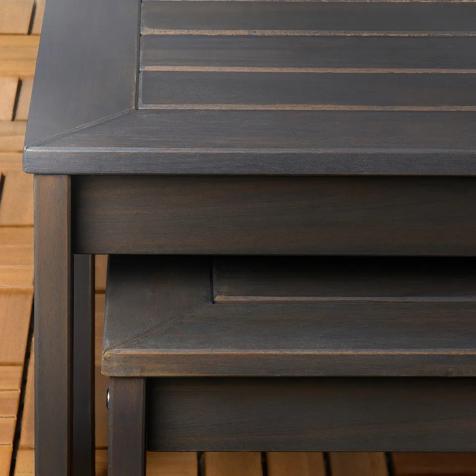 Dark wooden outdoor table with smooth, sturdy finish and visible grain. Designed for durability and aesthetic appeal in outdoor settings.