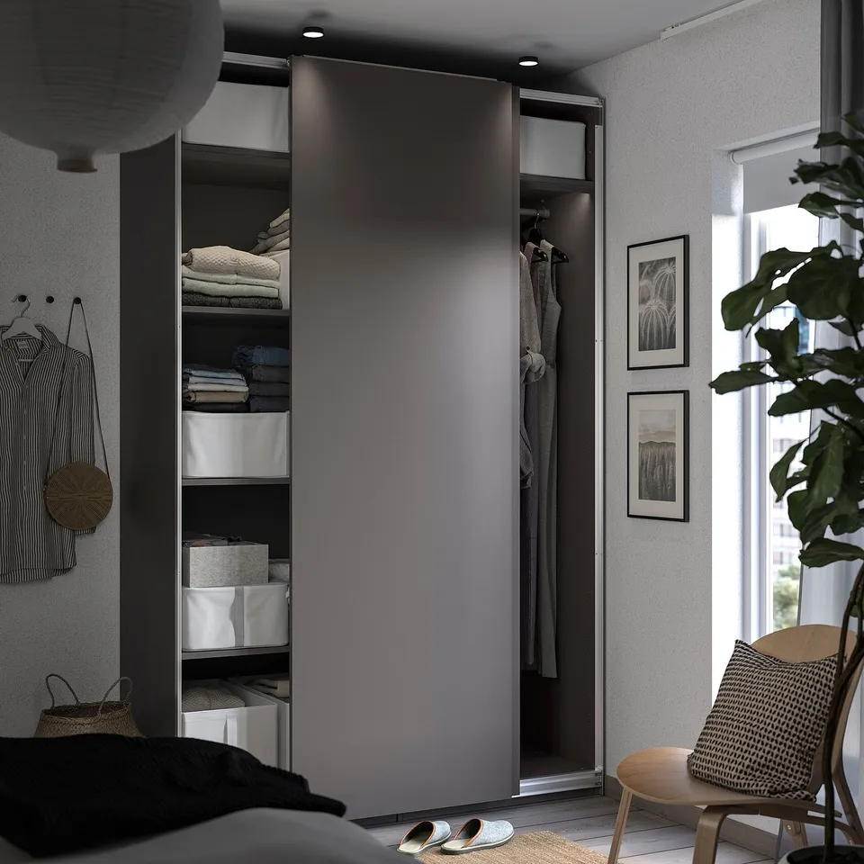 Modern grey sliding wardrobe, organised with shelves and hanging spaces. Clean lines and minimalist design.
