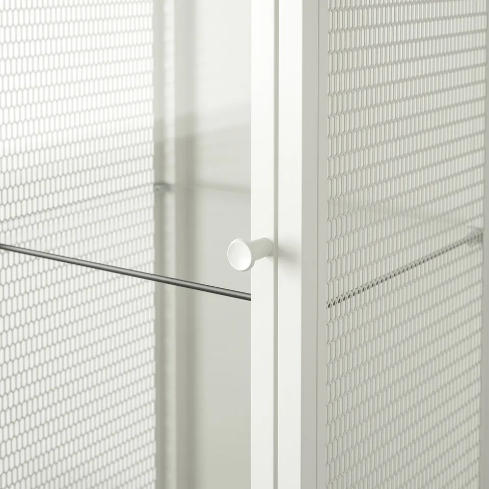 Modern glass and mesh cabinet with sleek handle, reflecting quality and style.