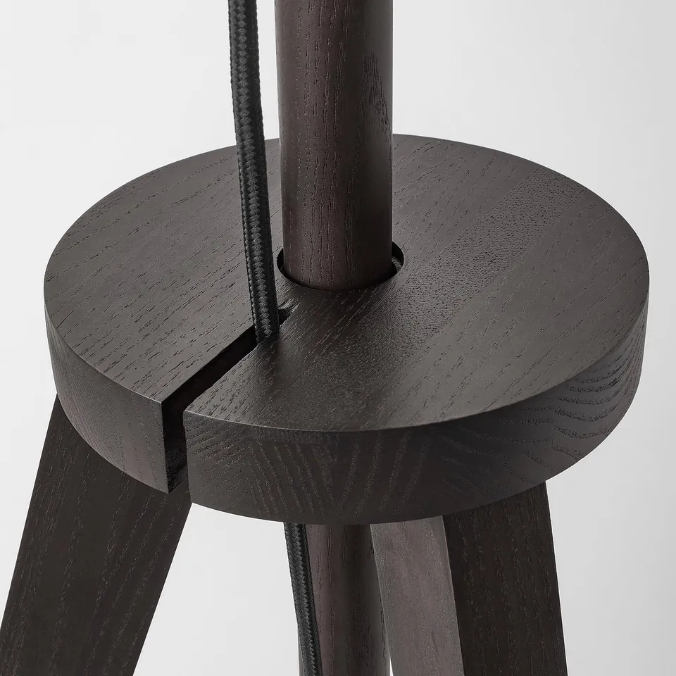 Solid black wooden lamp base with sleek design, featuring a central support and visible cable, exuding modern elegance.