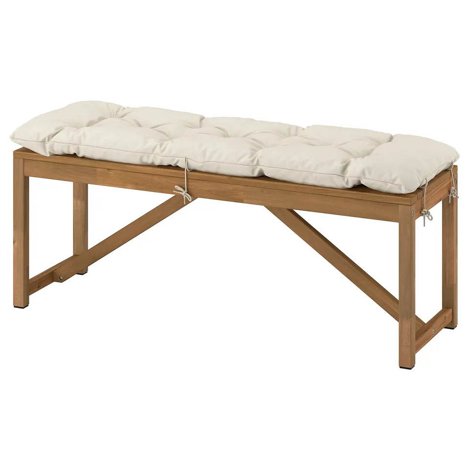 NÄMMARÖ bench with white cushion, made of acacia wood and polyester, rectangular shape, comfortable and simple design.