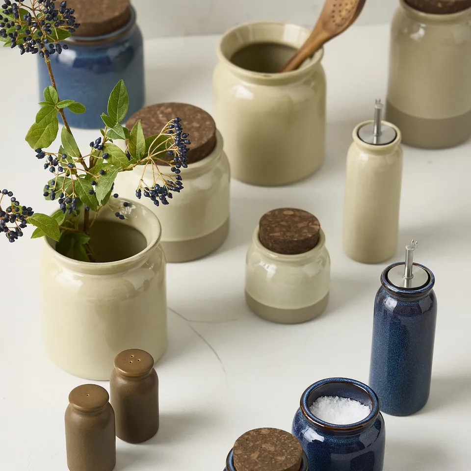 BRUGDHAJ collection: beige, blue stoneware jars, cork lids, different sizes, one with flowers, one with salt.