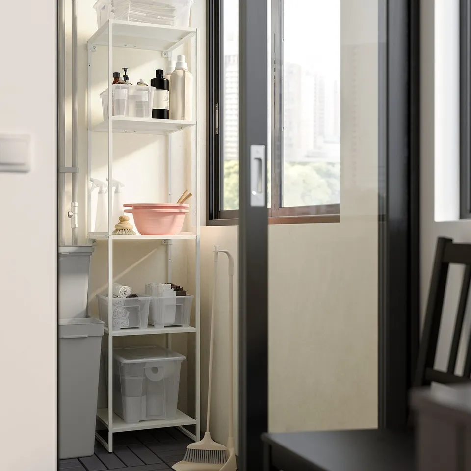 White JOSTEIN storage unit in bathroom; three shelves with cleaning supplies.