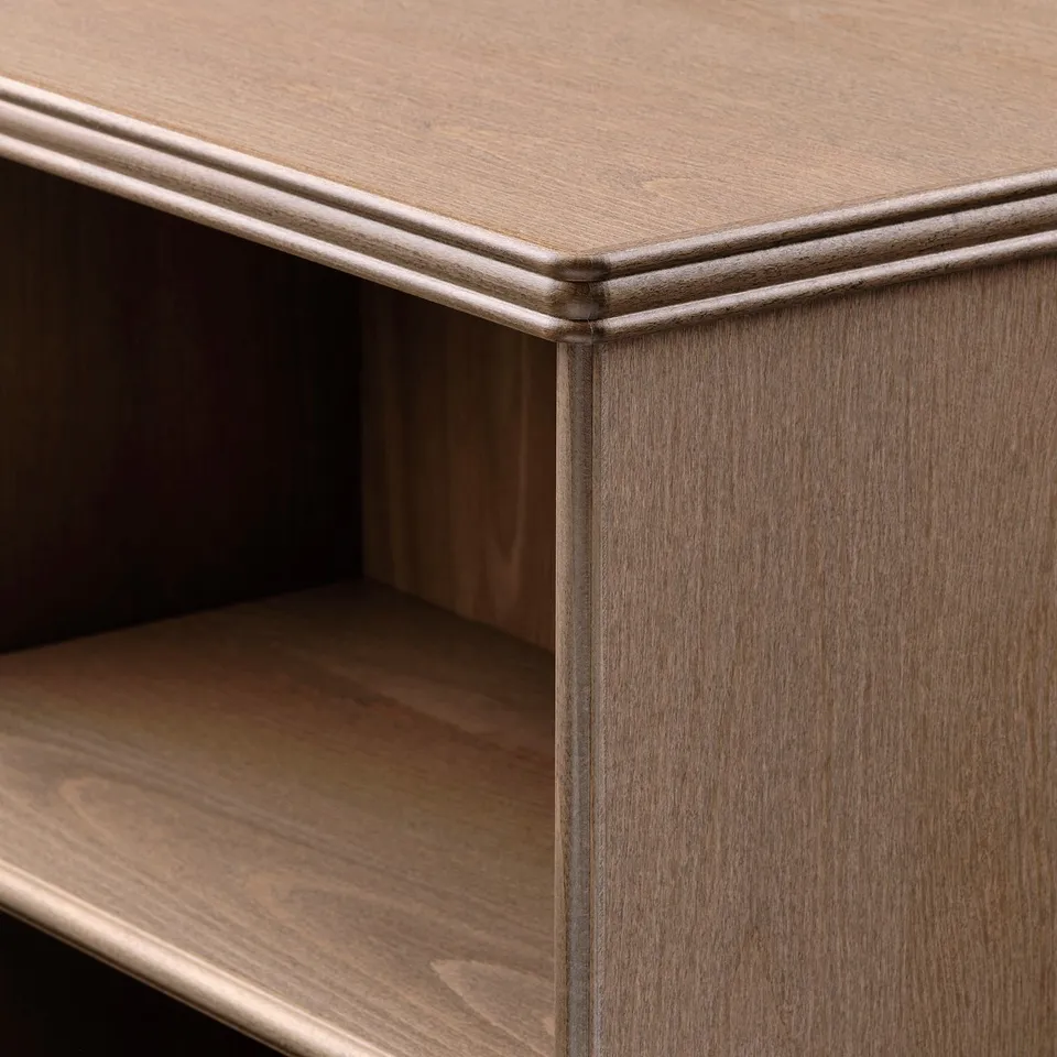 Wooden bookcase corner with fine craftsmanship, showcasing bevelled edges and sturdy shelves.