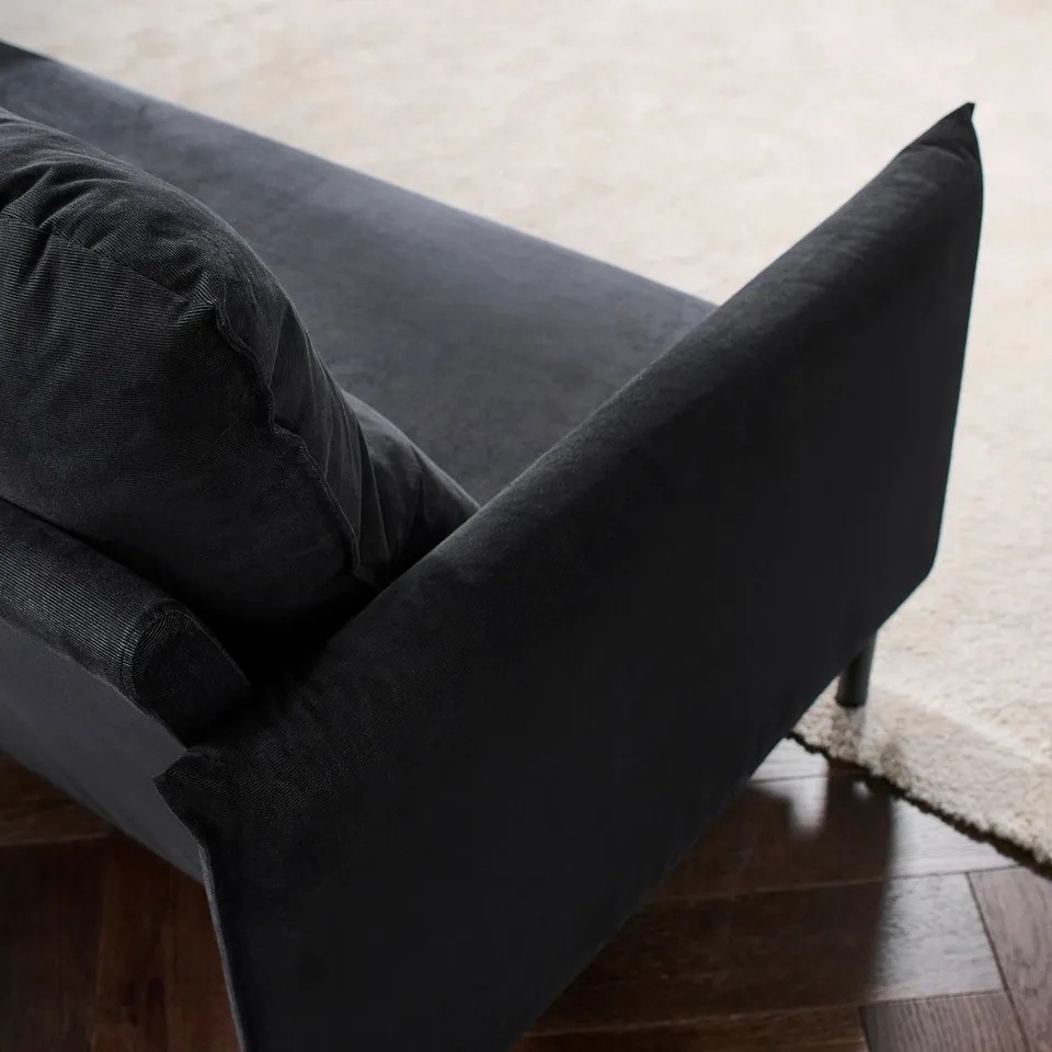 Sofa with plush cushions, high backrest, and elegant design. Soft, durable saxemara fabric. Modern, inviting appearance.