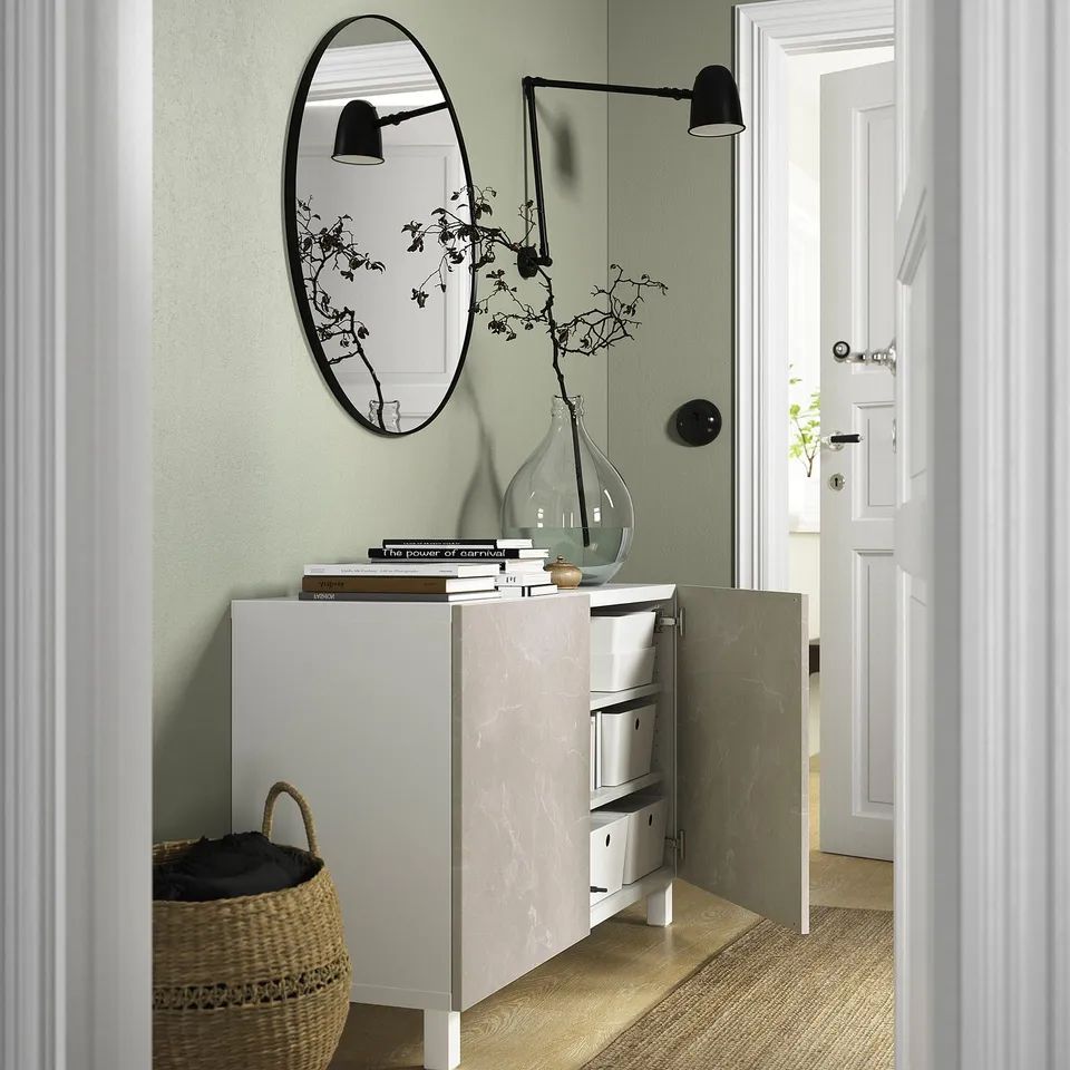 Modern entryway with BESTÅ sideboard, storage, and mirror.