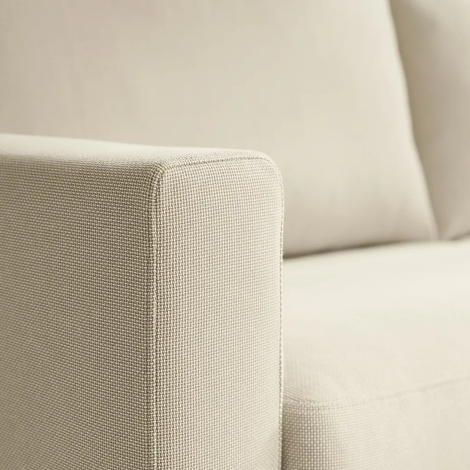 Close-up of a plush, textured sofa cushion, showcasing its soft, supportive fabric and high-quality stitching.