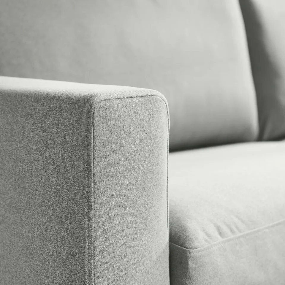 Close-up of soft, high-quality sofa cushion with clean lines and sleek fabric.