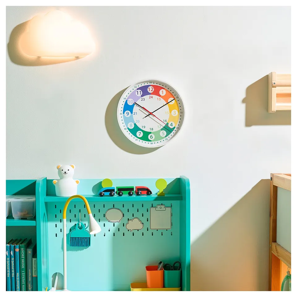 Bright bedroom with colourful clock and turquoise bookshelf.