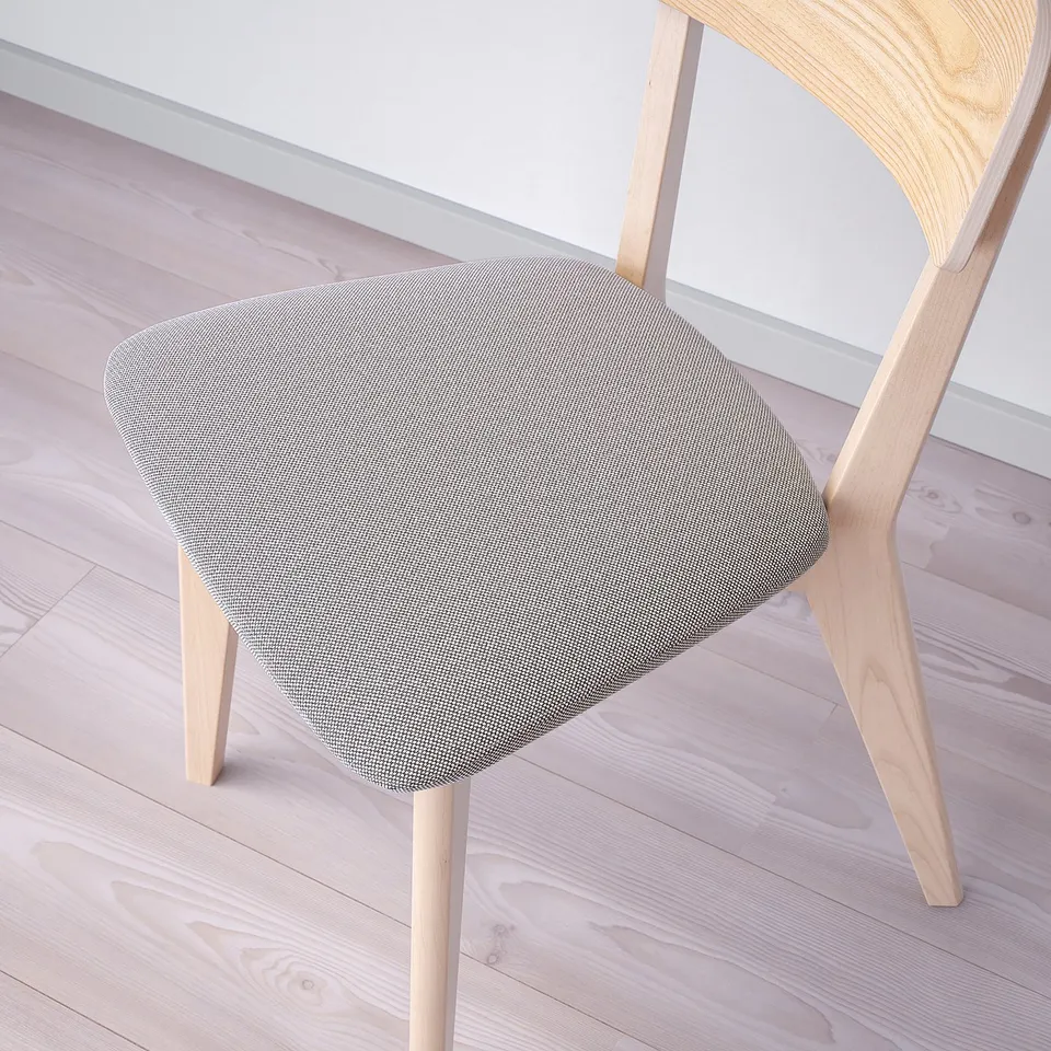 Chair with light wood frame, grey cushioned seat, elegant design, quality craftsmanship.