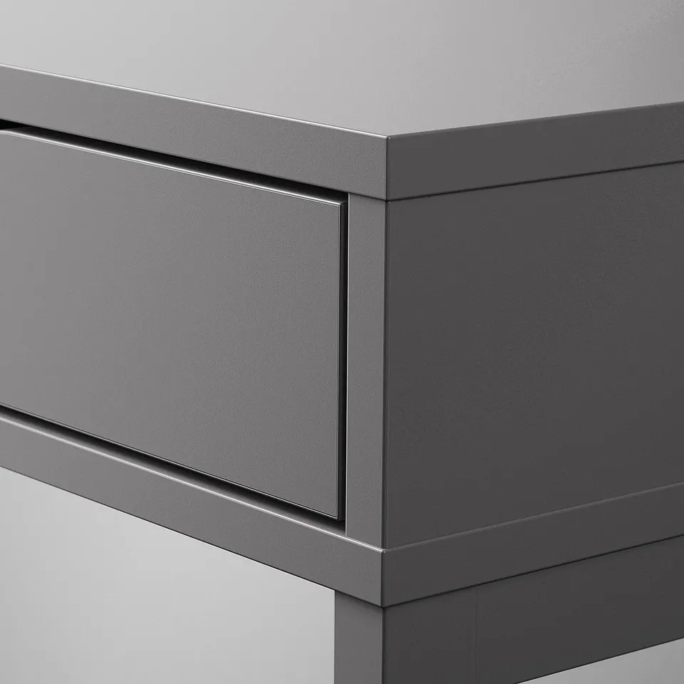 Dark grey modern desk with smooth edges and sleek design. Close-up shows high-quality finish and integrated drawers.