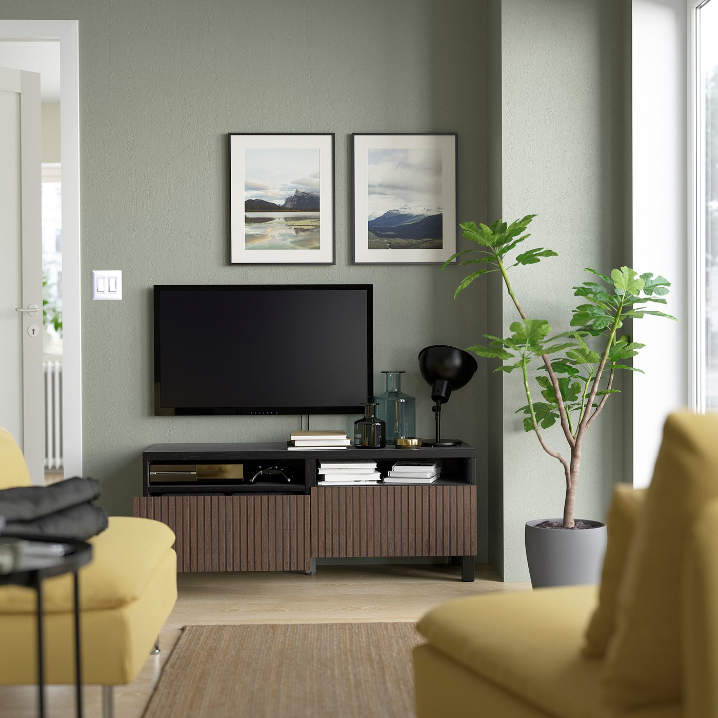 Modern living room with BESTÅ tv stand, featuring flat-screen tv, natural decor, and storage.
