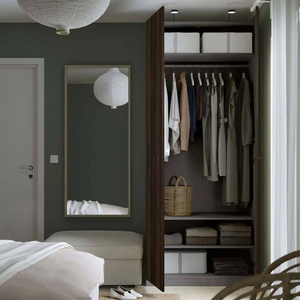 Modern bedroom with dark green wall, open closet PAX, and white bed