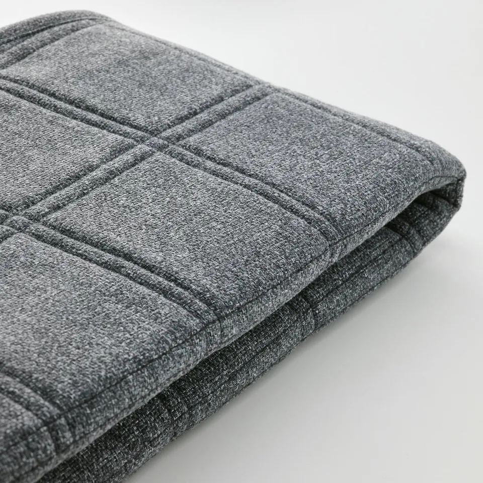 Closeup of grey LÄKTARE chair cover, showcasing soft, textured fabric with neat stitching and subtle pattern.