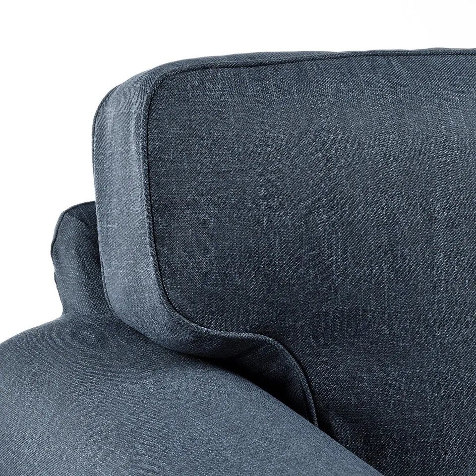 Grey upholstered sectional sofa with thick, cushioned seat and backrest, high-quality fabric, showcasing modern design.