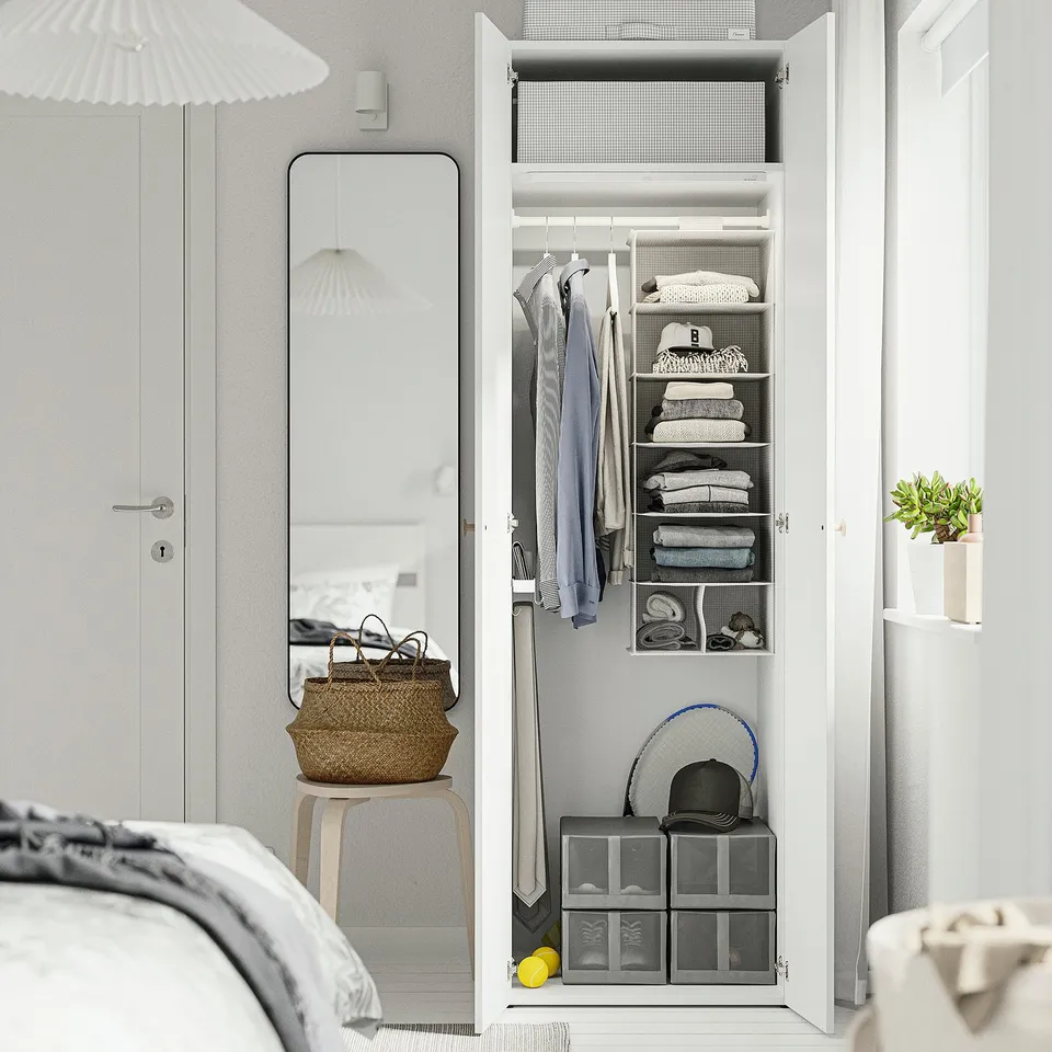 Open wardrobe with neatly folded clothes, hanging garments, and storage bins. Adjustable feet for floor levelling.