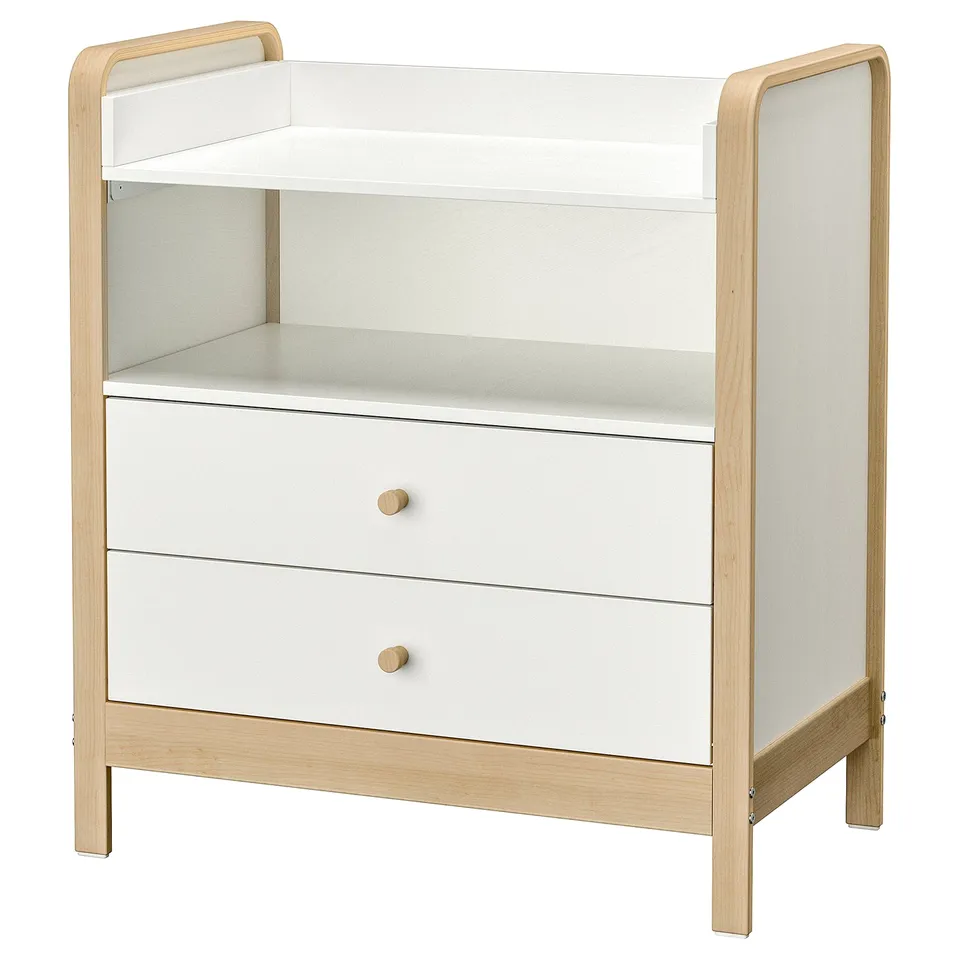 This is a white and light wood-colored changing table with two drawers, designed in a scandinavian style. It a changing top and storage shelves.