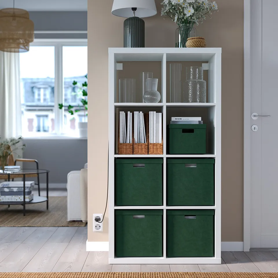 Modern living space with GJÄTTA green velvet storage boxes, sized for kallax shelves, storing books, vases, and decor.