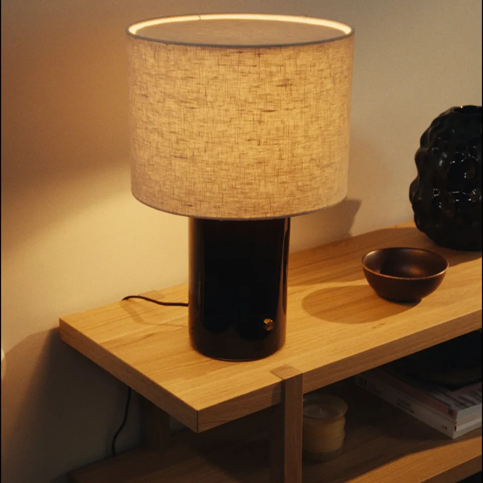 HALGATT lamp on wood shelf, warm shade, ceramic base, brass knob, vase, bowl.