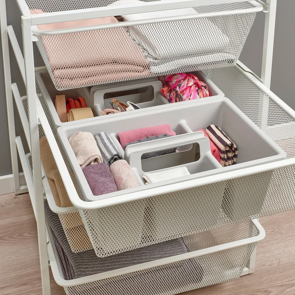White mesh JONAXEL storage drawers with folded clothes and accessories, keeping items organised and tidy.