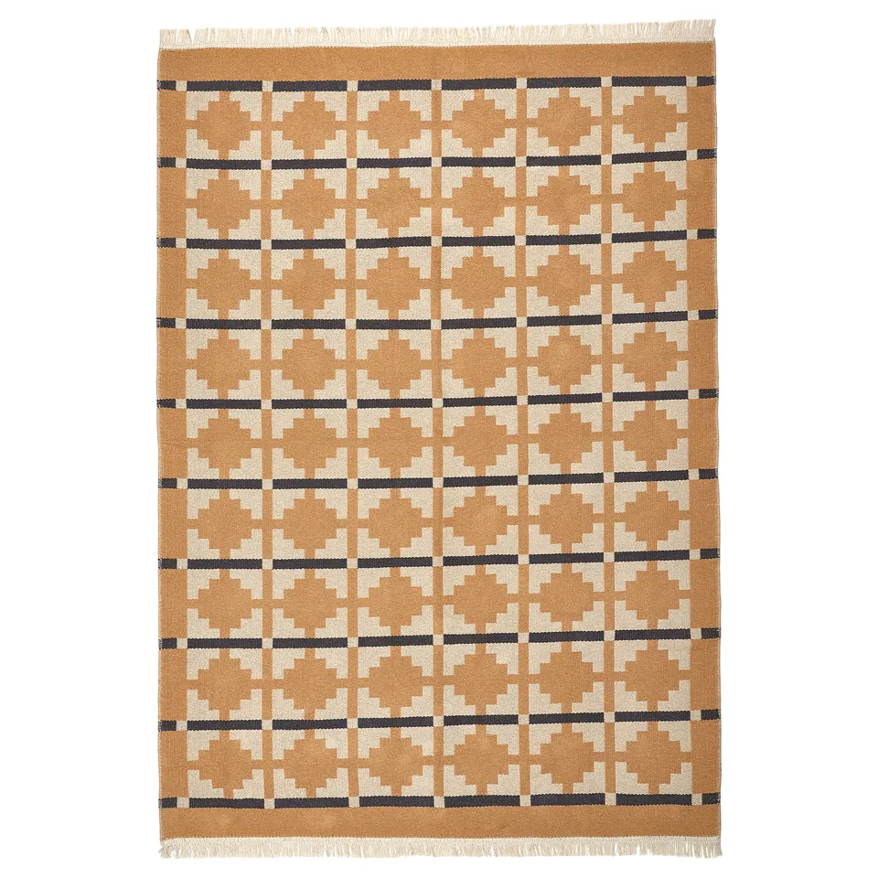 A TELEGRAFLINJE rug in earthy tones with a geometric pattern, made of cotton, rectangular with fringed edges, suitable for various rooms.