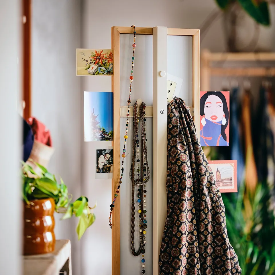 Mirror with photos, notes, and hanging items.