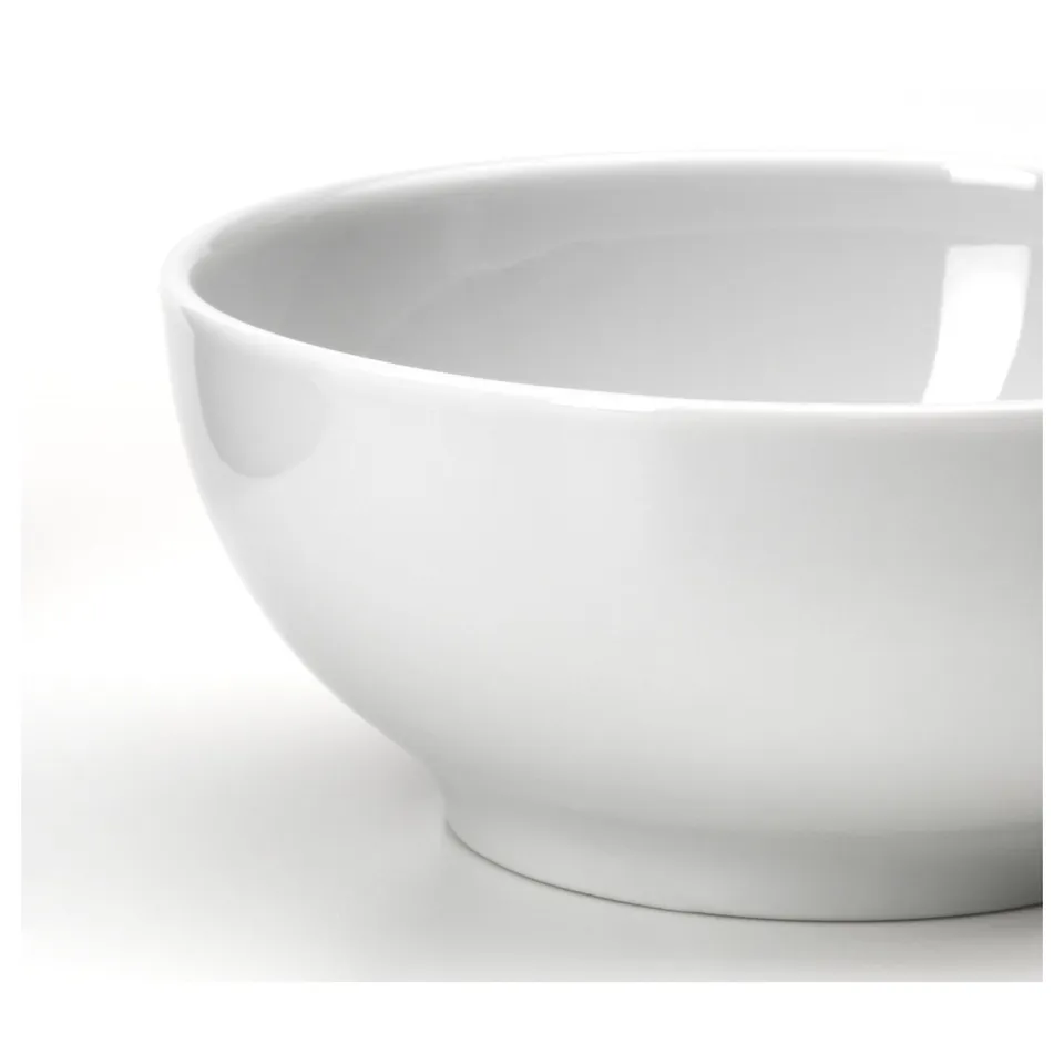 A clean white bowl, made of durable porcelain, sits against a white background, showcasing its smooth and glossy finish.