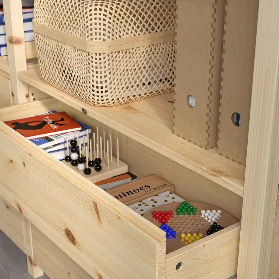 Wooden storage unit with drawers and shelves, holding toys, books, and games.