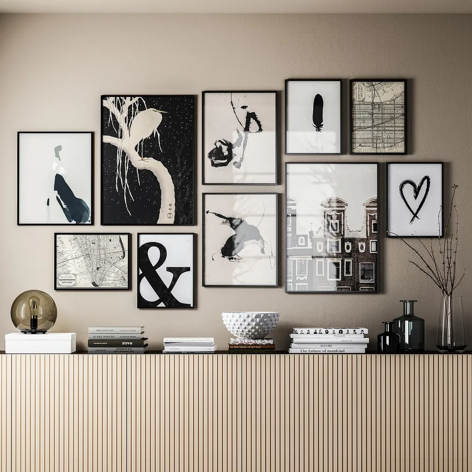 Black-and-white photo gallery on wall, sideboard with decor items below.