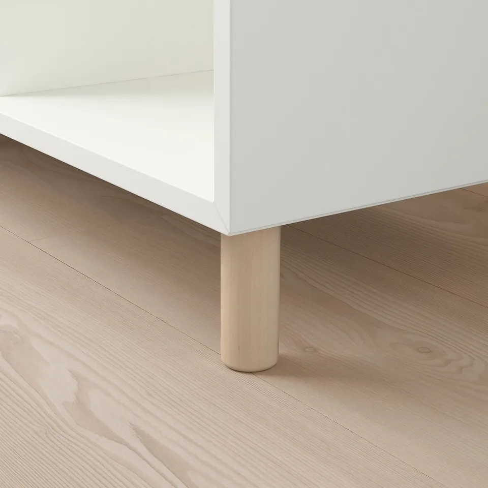 Modern white cabinet with sleek wooden legs. Quality design, sturdy and stylish.