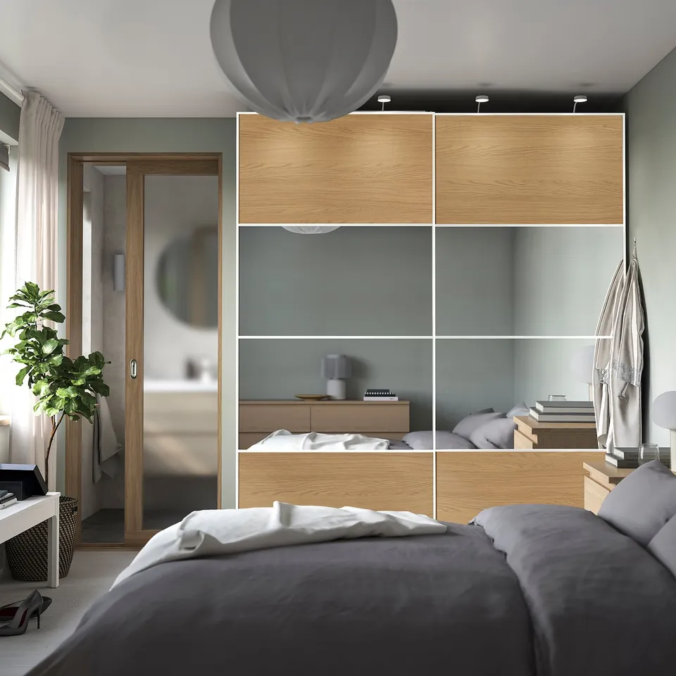 Modern bedroom with PAX wardrobe. Large, wooden & glass, organised with shelves & drawers.