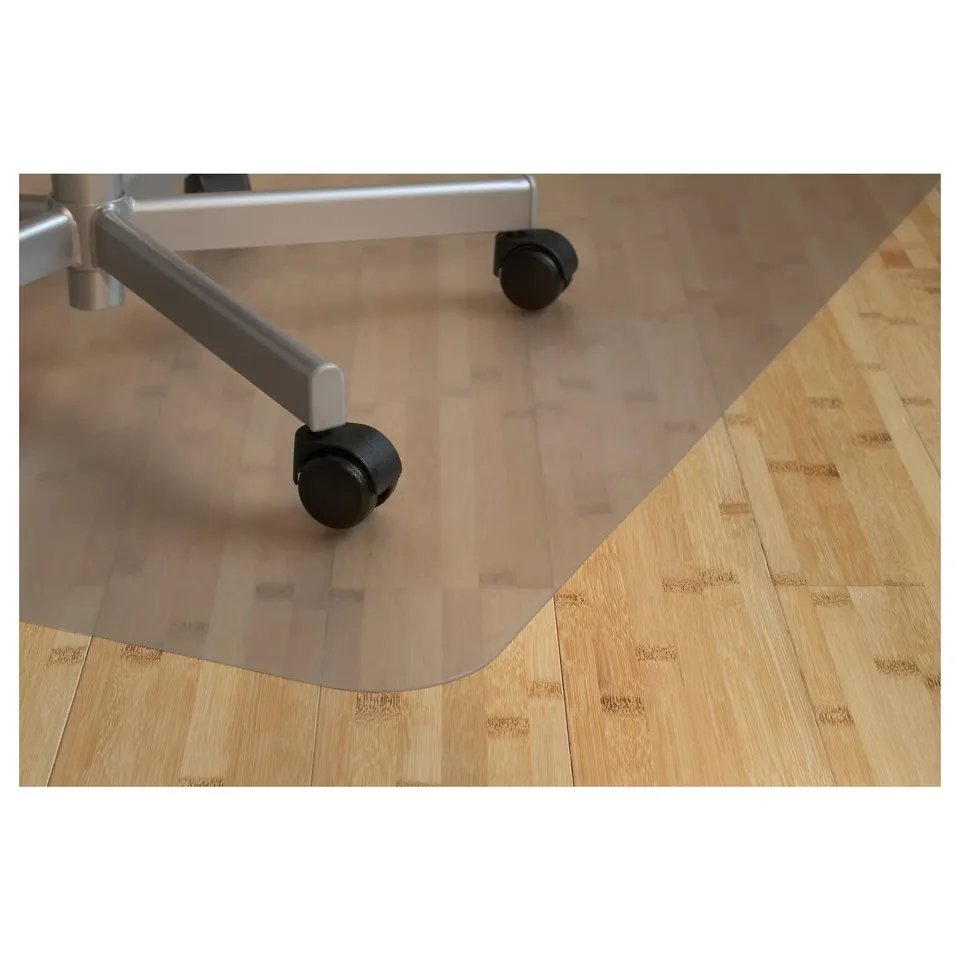 Transparent chair mat on wooden floor with castor wheels.