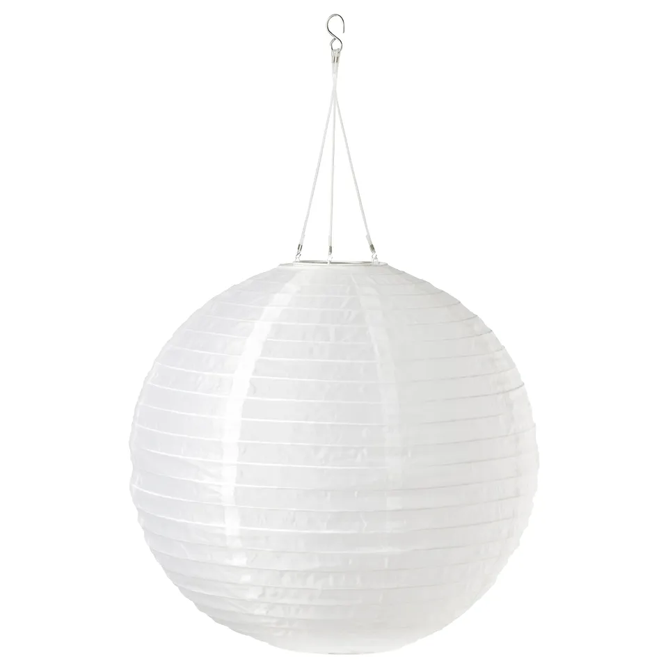 Round white solar lantern hangs from string. Made from recycled pet bottles.