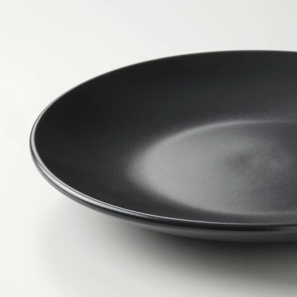Black side plate with smooth, glossy finish on white background.