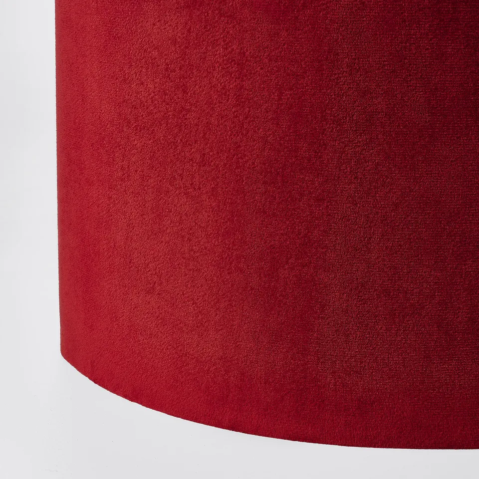 Close-up of luxurious red velvet lampshade, smooth texture, warm & inviting.