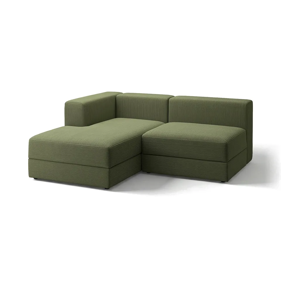 The green JÄTTEBO modular sofa with a chaise section, showcasing a sleek, modern design with a soft, corduroy texture.