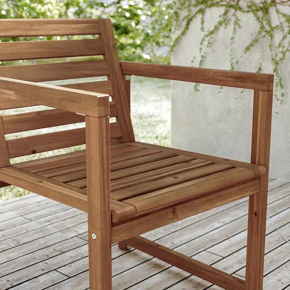 Brown NÄMMARÖ acacia wood chair, outdoor, slatted seat & back.
